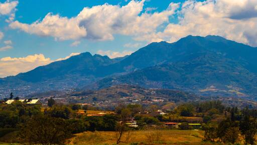Runway airport city mountains panorama view from airplane Costa Rica.
