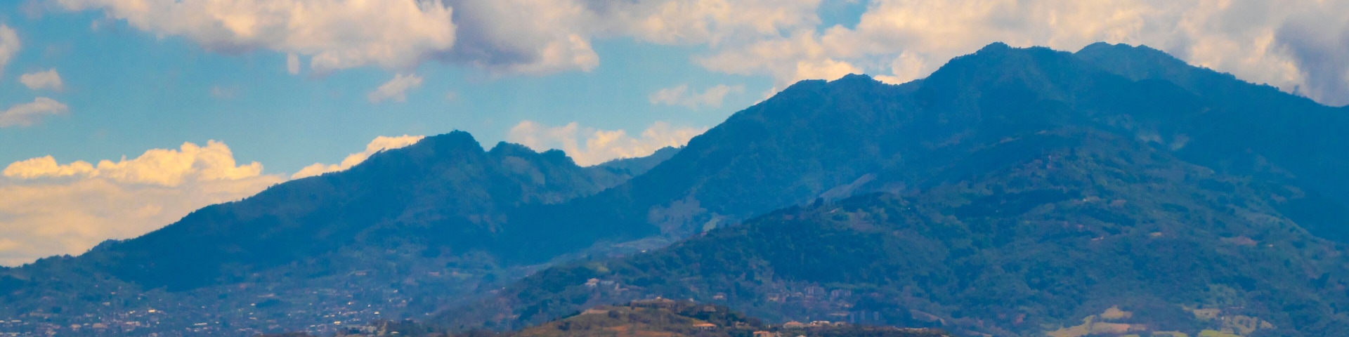 Runway airport city mountains panorama view from airplane Costa Rica.