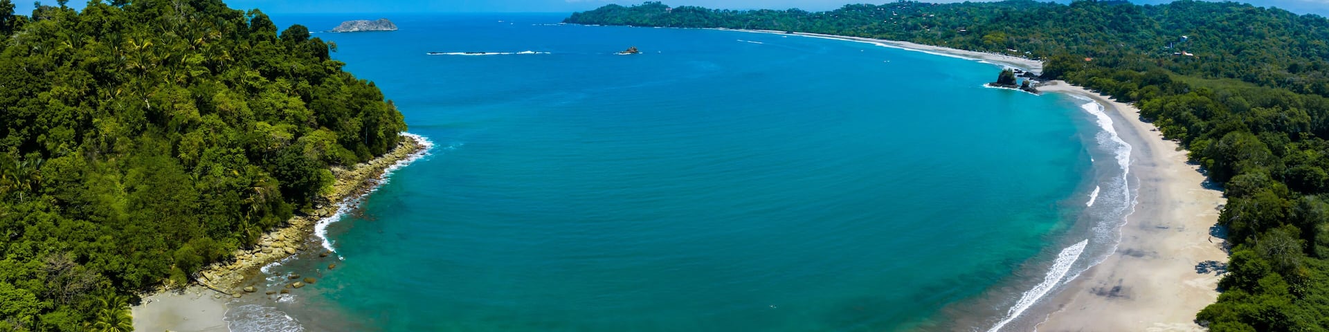 Aerial view of Manuel Antonio National Park in Costa Rica. The best Tourist Attraction and Nature Reserve with lots of Wildlife, Tropical Plants and paradisiacal Beaches on the Pacific Coast.