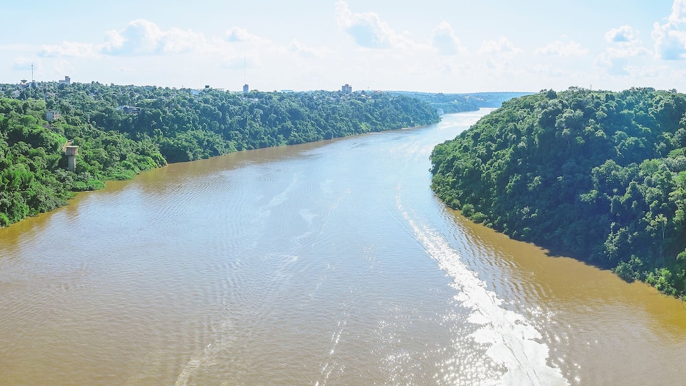 Panoramic photo taken over the Tancredo Neves bridge from the Iguacu river and the borders from Brazil and Argentina. On the right side is Brazil, on the left is Argentina.
