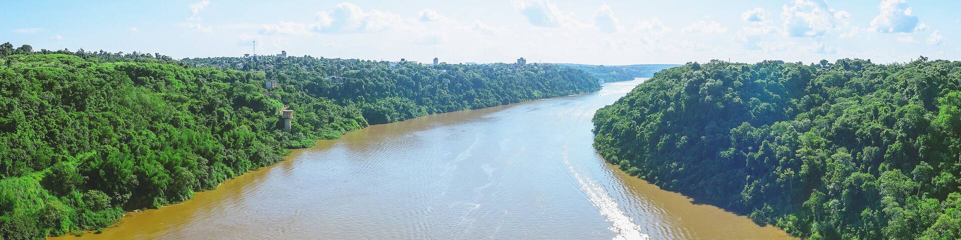 Panoramic photo taken over the Tancredo Neves bridge from the Iguacu river and the borders from Brazil and Argentina. On the right side is Brazil, on the left is Argentina.