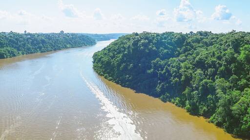 Panoramic photo taken over the Tancredo Neves bridge from the Iguacu river and the borders from Brazil and Argentina. On the right side is Brazil, on the left is Argentina.