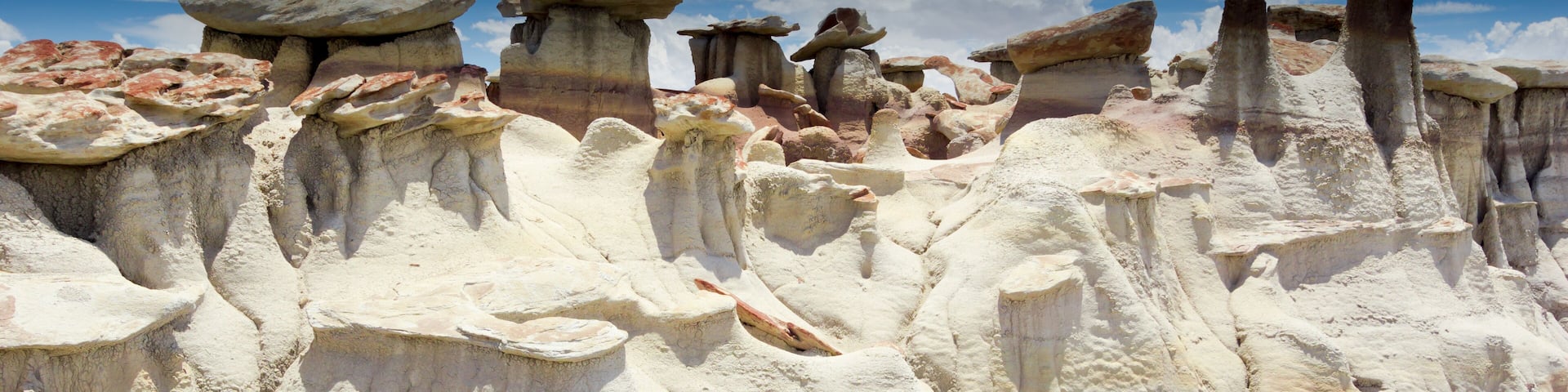 A landscape of unique rock formations with layered textures and varying heights.