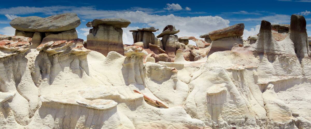 A landscape of unique rock formations with layered textures and varying heights.