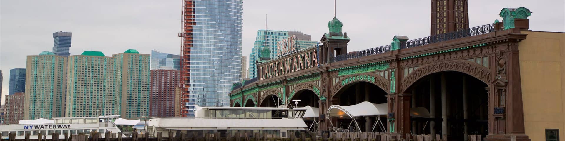 A historic bridge with a clock tower, a modern skyscraper, and a river.