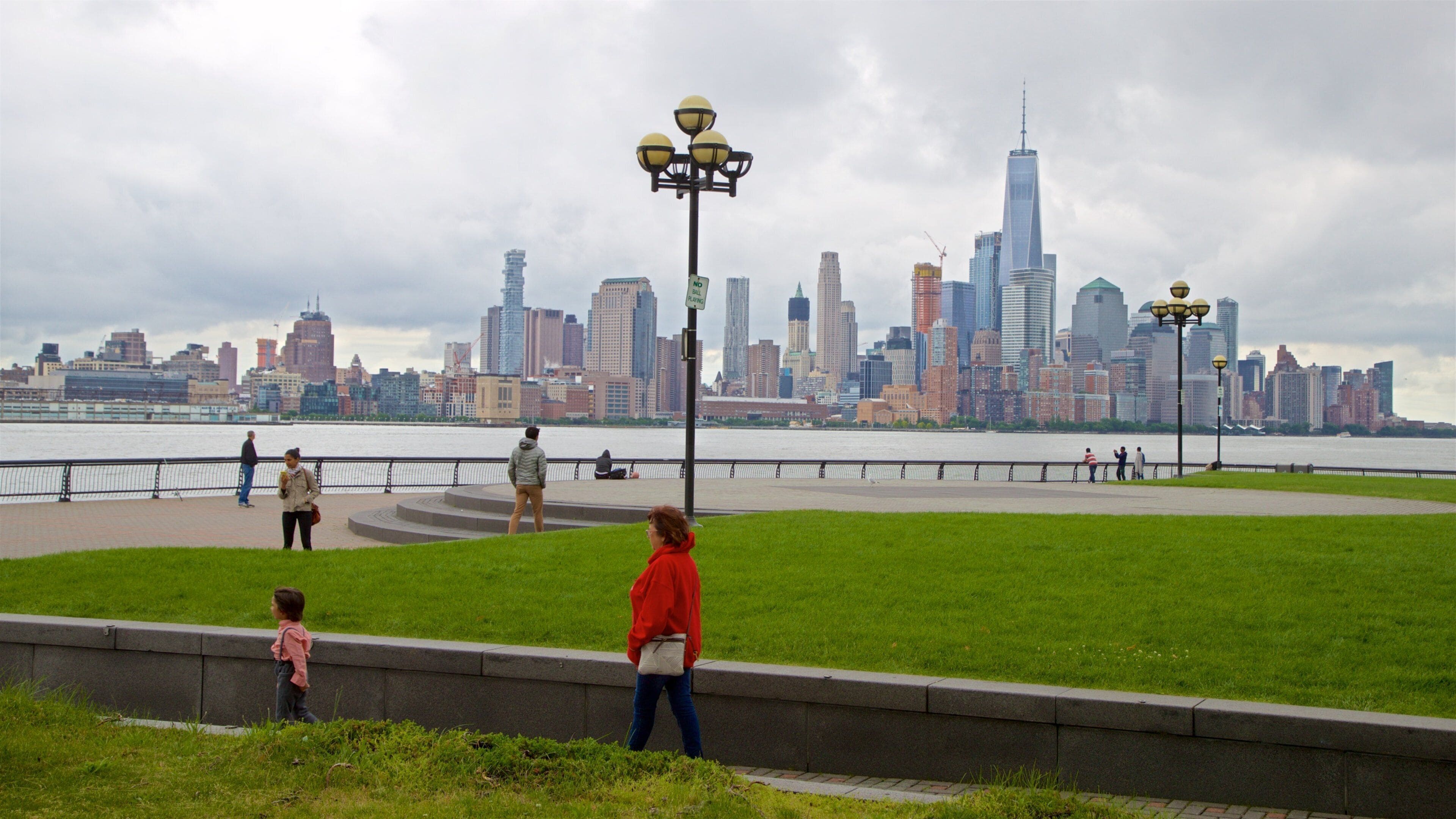 Pier A Park featuring a river or creek, a high-rise building and a city