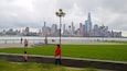 A waterfront park with a city skyline in the background.