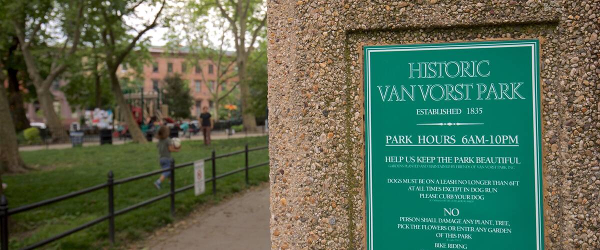 Van Vorst Park featuring signage and a park