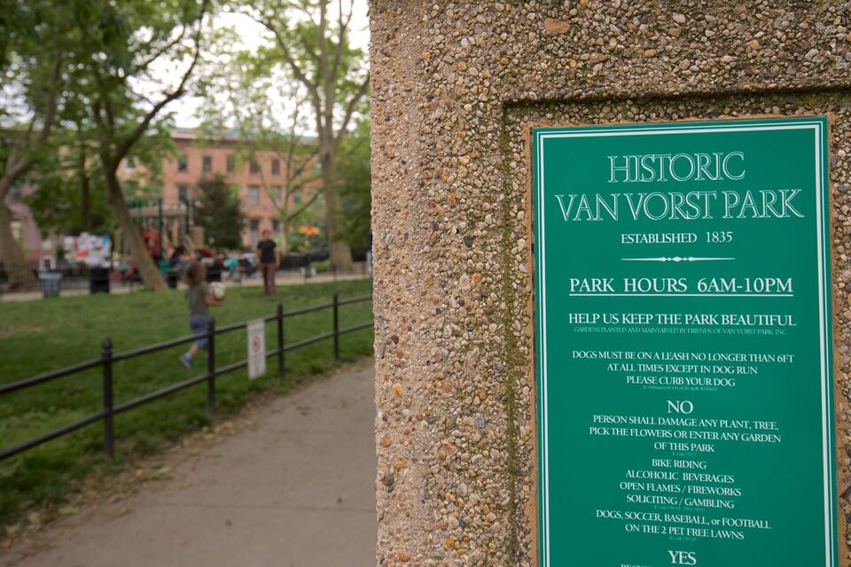 A sign for Historic Van Vorst Park with park hours and rules.