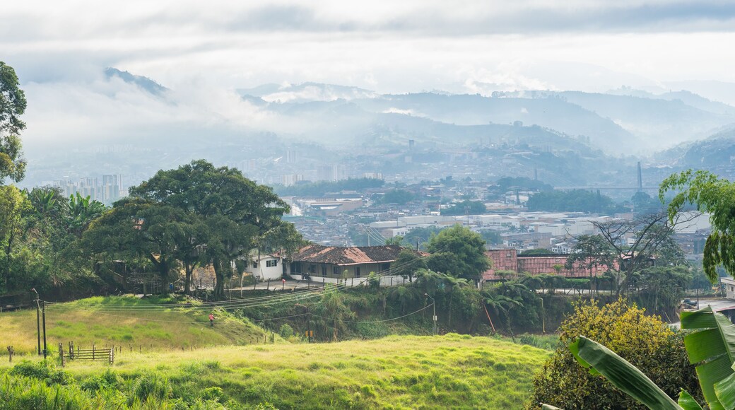 beautiful panoramic view in the municipality of Dosquebradas-Risaralda, Colombia seen from the mountains. farm near the city of Pereira on a cold morning while the beautiful golden morning sun rises.