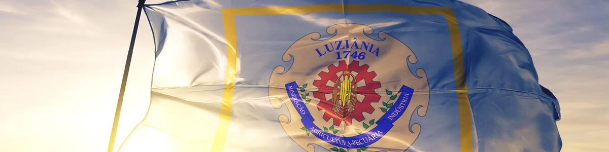 Luziania of Brazil flag waving on the top sunrise mist fog