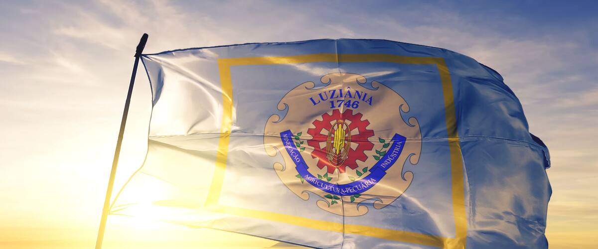 Luziania of Brazil flag waving on the top sunrise mist fog