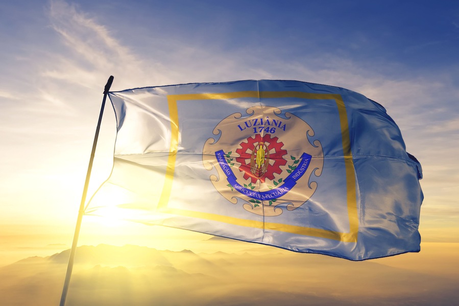 Luziania of Brazil flag waving on the top sunrise mist fog