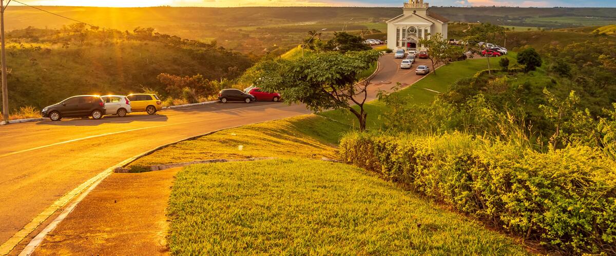 A church on a hill with a sunset in the background.