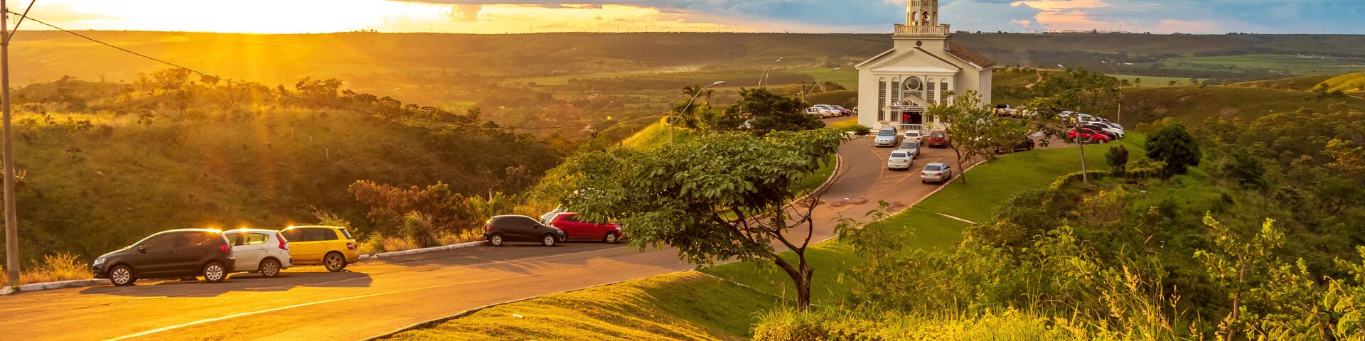 A church on a hill with a sunset in the background.