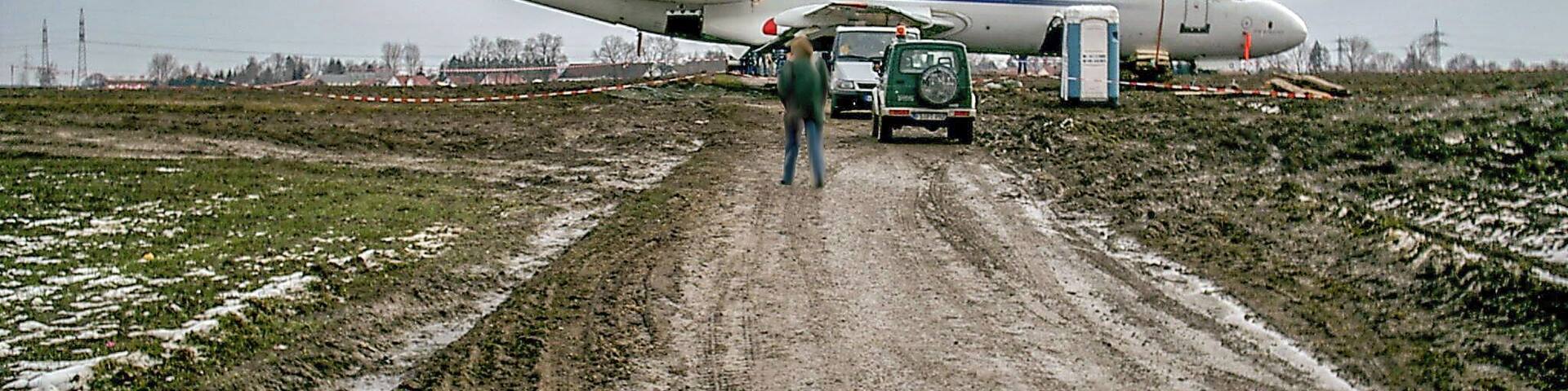 Fokker 70 (OE-LFO) by Austrian Airlines few days after crash landing in Reisen near Munich Airport; plane has already been moved to a nearby street; registration code and airline logos are covered;