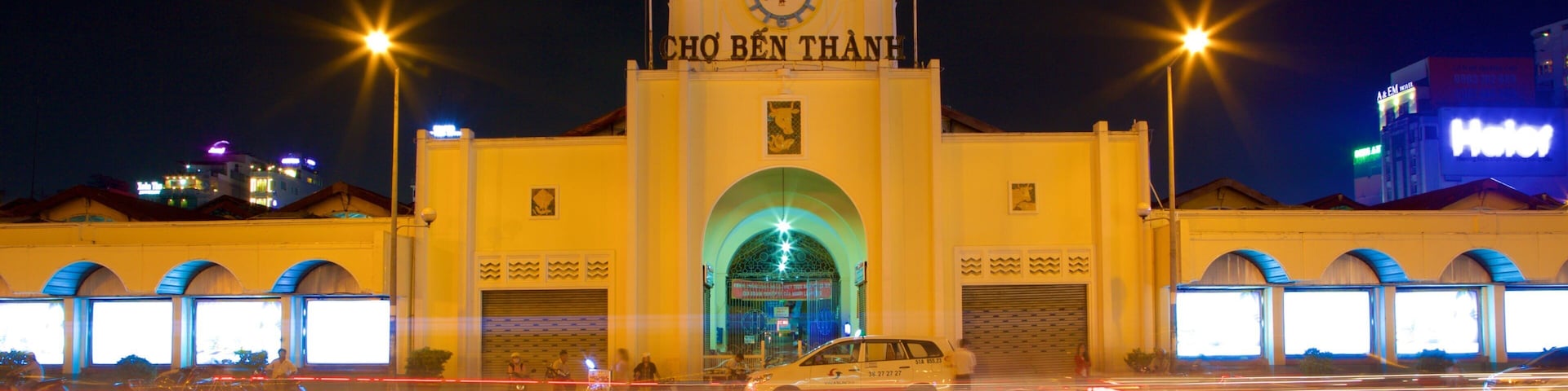 Ben Thanh Market showing heritage architecture, signage and night scenes