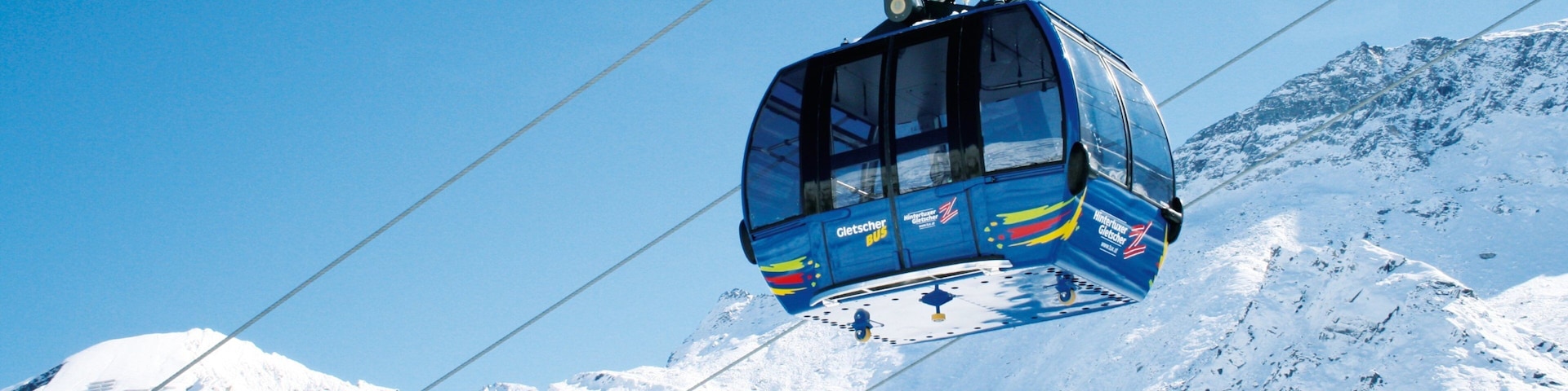 Hintertux Glacier Ski Resort showing a gondola, mountains and snow