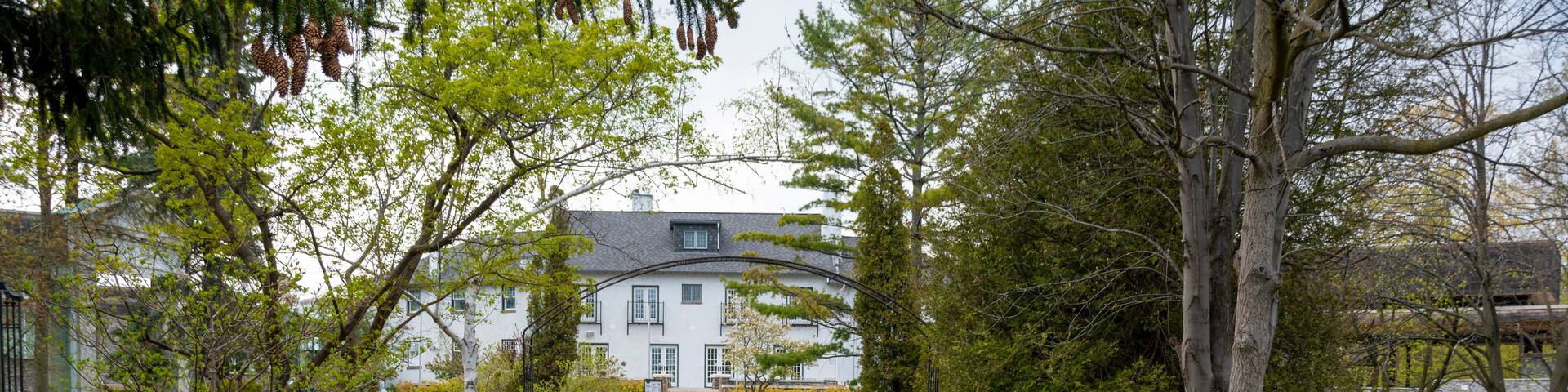 A sculpture, a remnant of an old building long since demolished, sits in the center of a large flower pot in the Guild Inn's Garden of Ruins in Scarborough (Toronto), Ontario.
