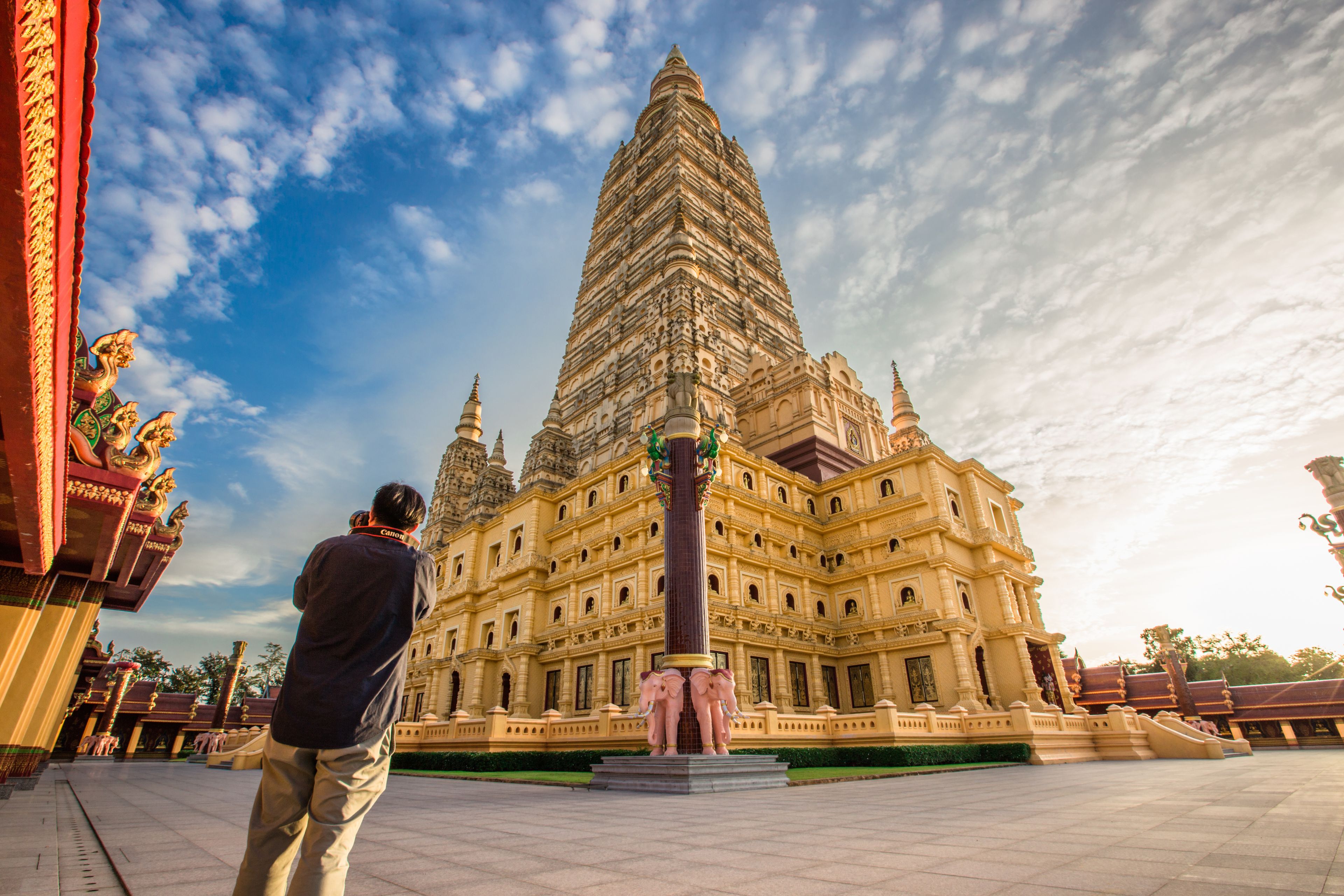 A large temple with a tall spire, intricate carvings, and a statue of a deity.