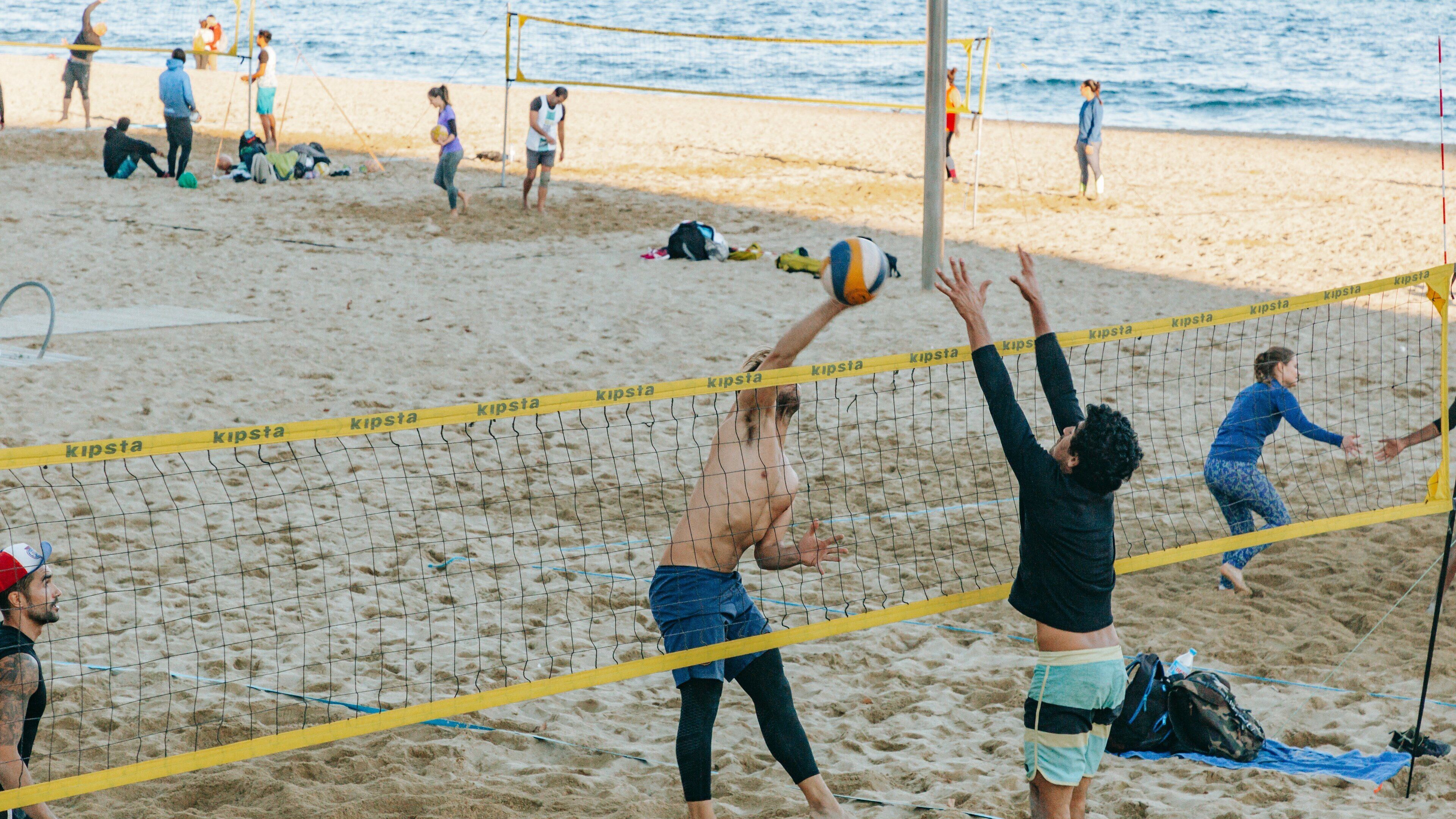 Bogatell Beach featuring a sandy beach as well as a small group of people