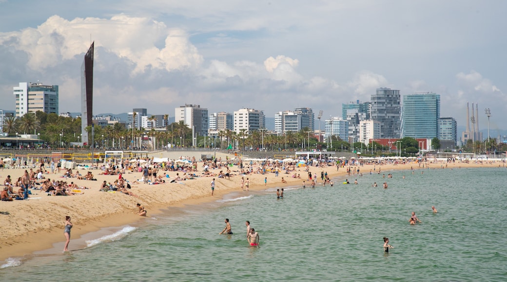 Bogatell Beach showing swimming, a coastal town and general coastal views