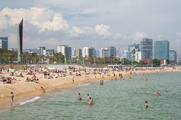 Bogatell Beach showing swimming, a coastal town and general coastal views
