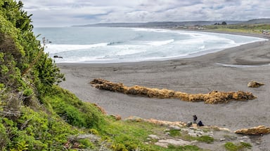 La Rinconada Beach close to Cobquecura town is a wild beach with a wonderful scenery. Big waves approaches the coast and impact to the sand dunes on the beach where the fishermen boats wait. Chile
