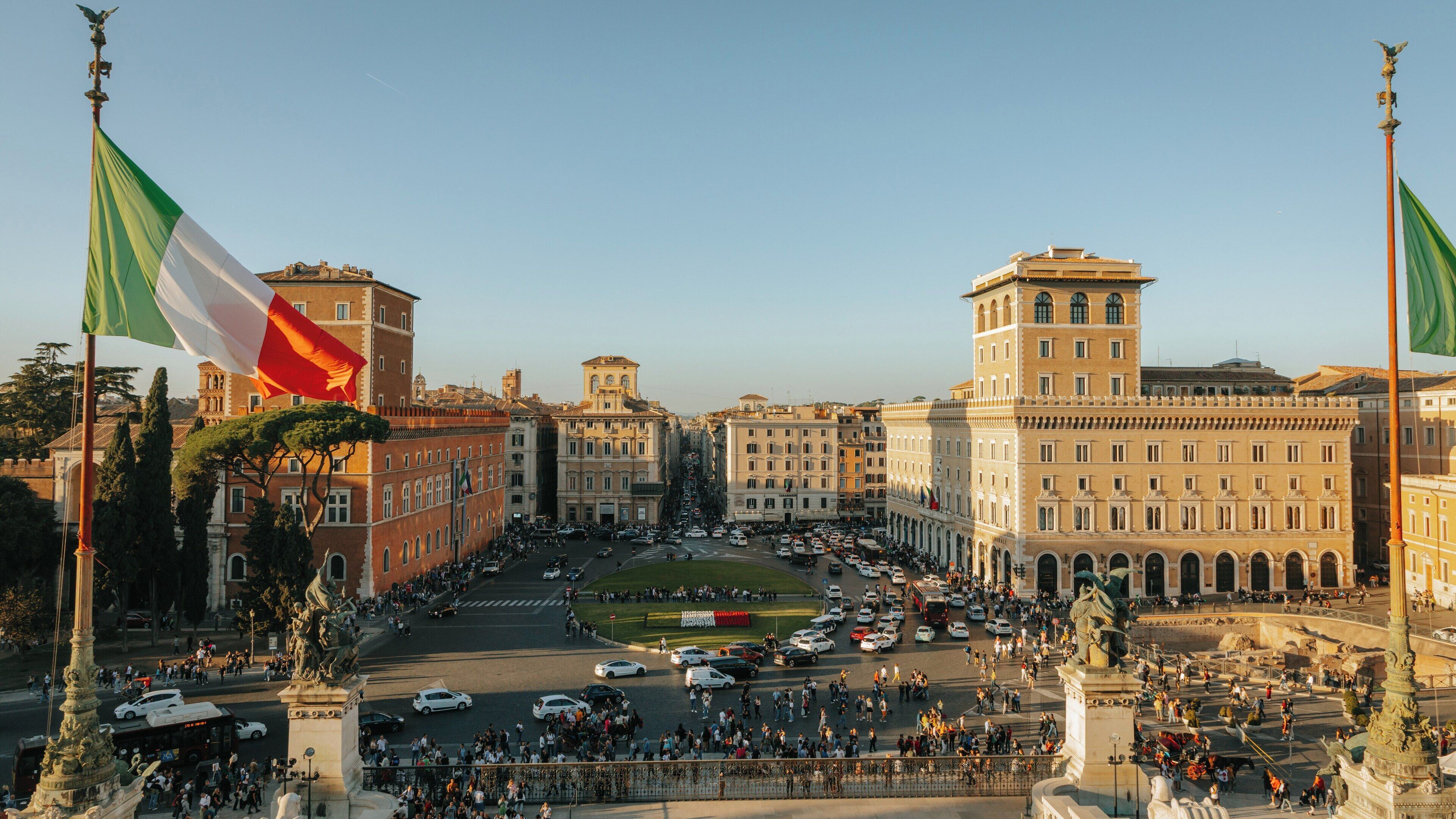 Views of the National Monument to Victor Emmanuel II in the Historic Center of Rome at sunset, capturing vibrant city life and architecture