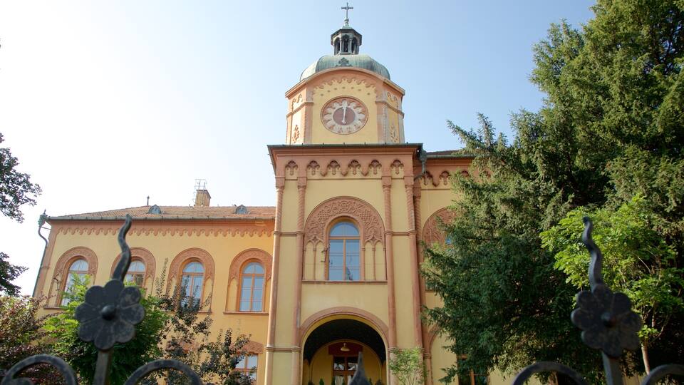 A historic building with a clock tower, arched windows, and ornate decorations.