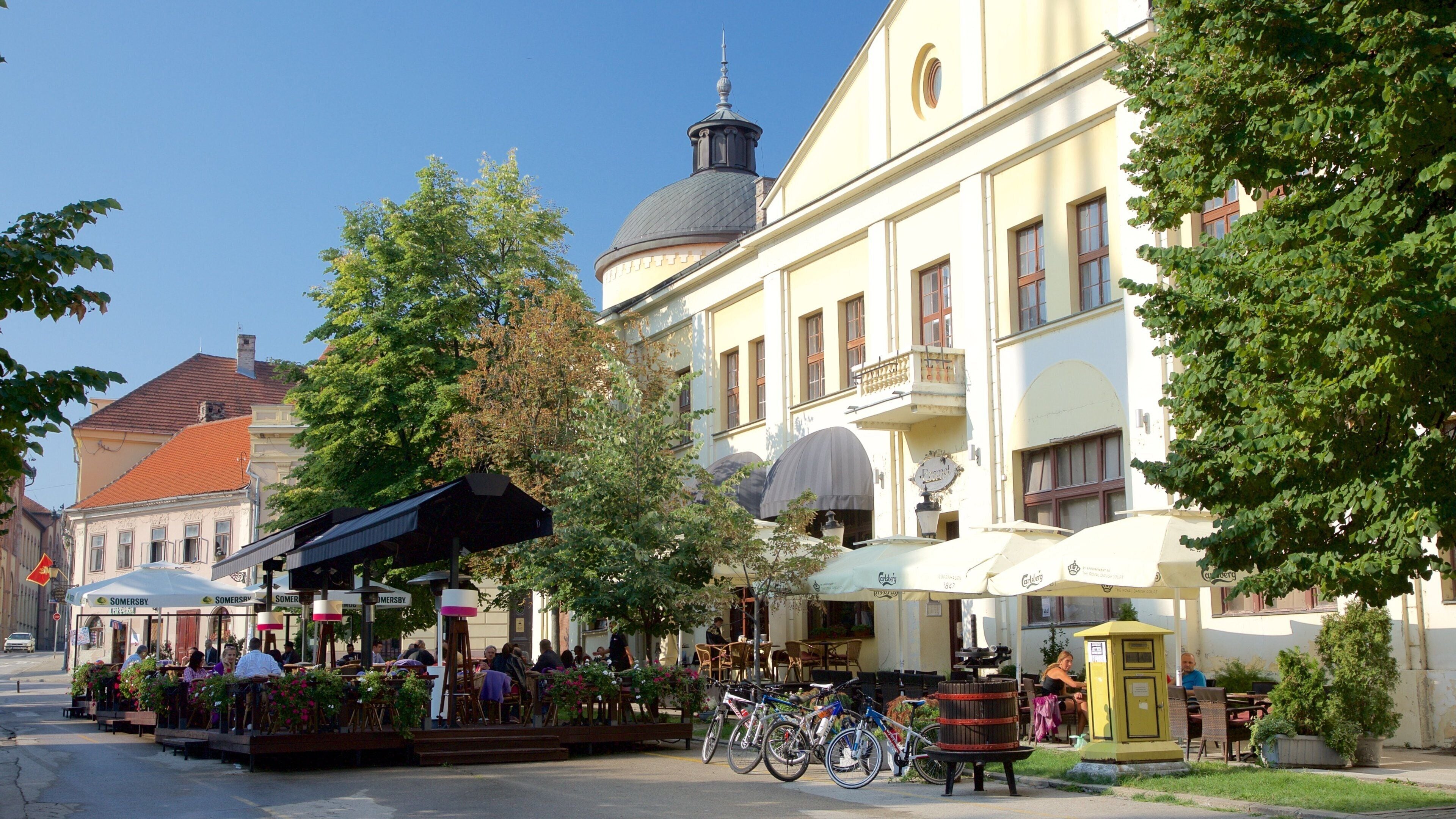 A street with outdoor cafes, bicycles, and historic buildings.