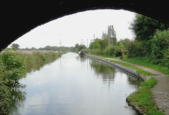 Birmingham and Fazeley Canal near Curdworth, Warwickshire Seen from beneath the arch of Wiggins Hill Bridge. The original purpose of this canal was to provide a link between Birmingham and the south east of England, by way of the Coventry Canal and the Oxford Canal. John Smeaton was the engineer, and the canal was completed in 1789.