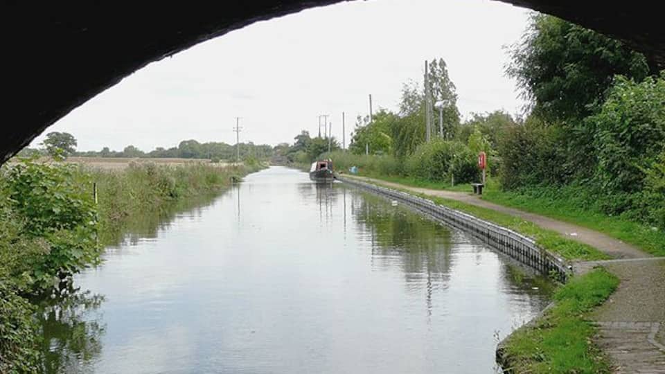 Birmingham and Fazeley Canal near Curdworth, Warwickshire Seen from beneath the arch of Wiggins Hill Bridge. The original purpose of this canal was to provide a link between Birmingham and the south east of England, by way of the Coventry Canal and the Oxford Canal. John Smeaton was the engineer, and the canal was completed in 1789.