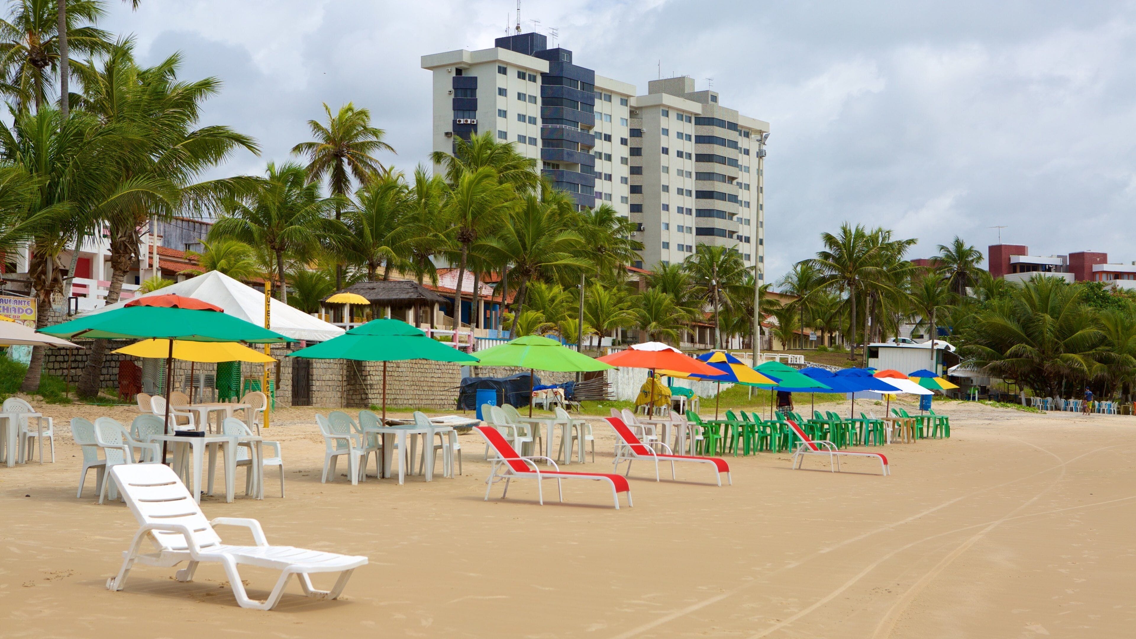 Pirangi Beach showing a coastal town, a sandy beach and general coastal views