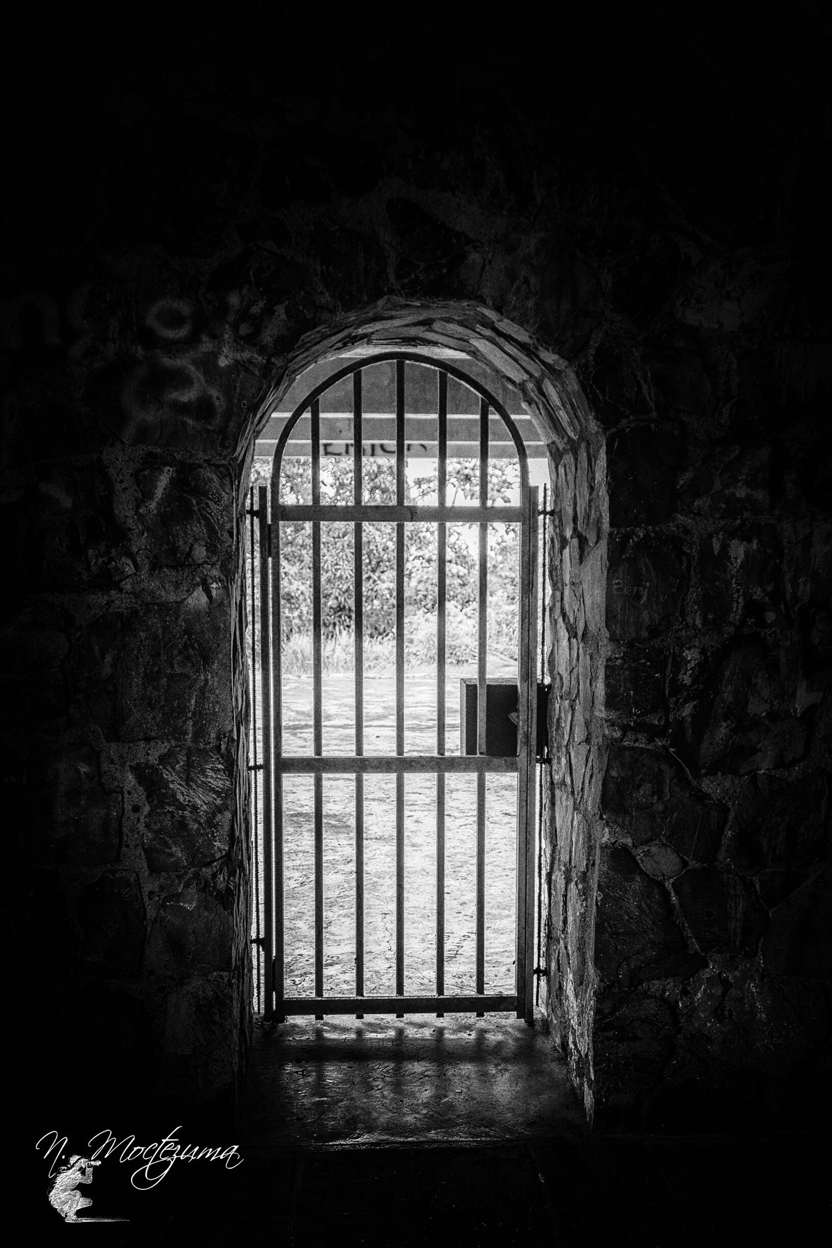 A stone archway with a metal gate.