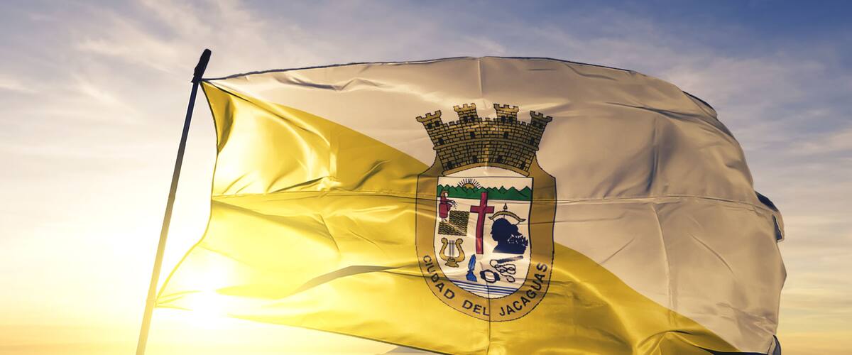 Juana Diaz municipality of Puerto Rico flag waving on the top sunrise mist fog