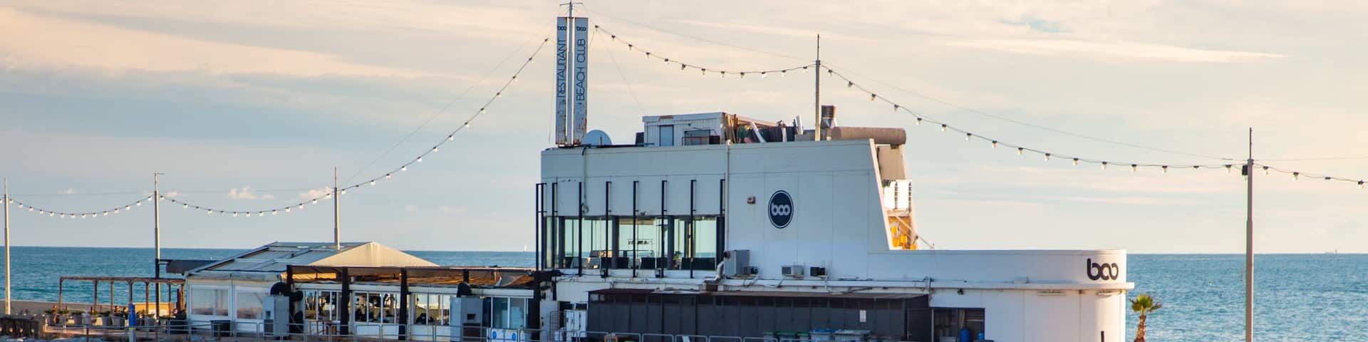 Mar Bella Beach which includes general coastal views and a beach as well as a couple