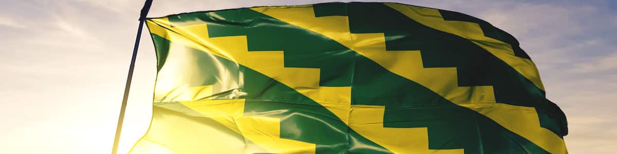 Gurabo municipality of Puerto Rico flag waving on the top sunrise mist fog