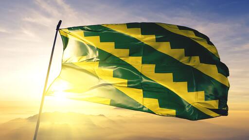 Gurabo municipality of Puerto Rico flag waving on the top sunrise mist fog