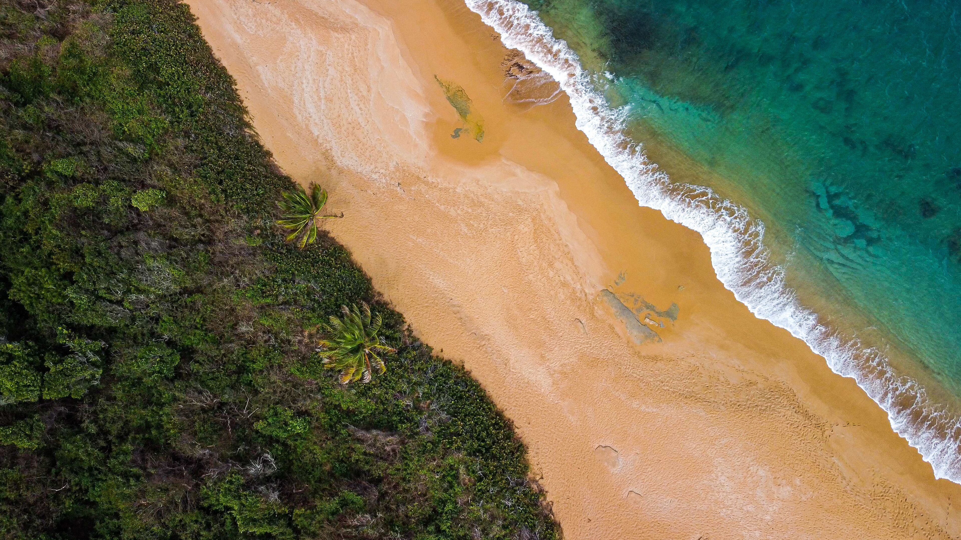  Red sand beach on tropical island from above 