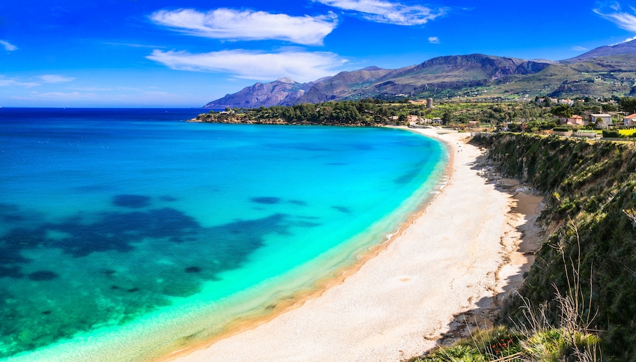 Empty tropical-like beach in Scopello, Sicily. Crystal clear turquoise water and white sand at Zingaro Nature Reserve, Italy. No people