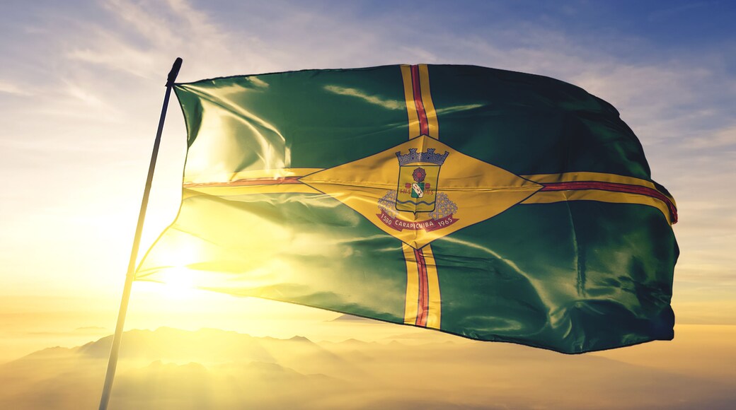 Carapicuiba of Brazil flag waving on the top sunrise mist fog