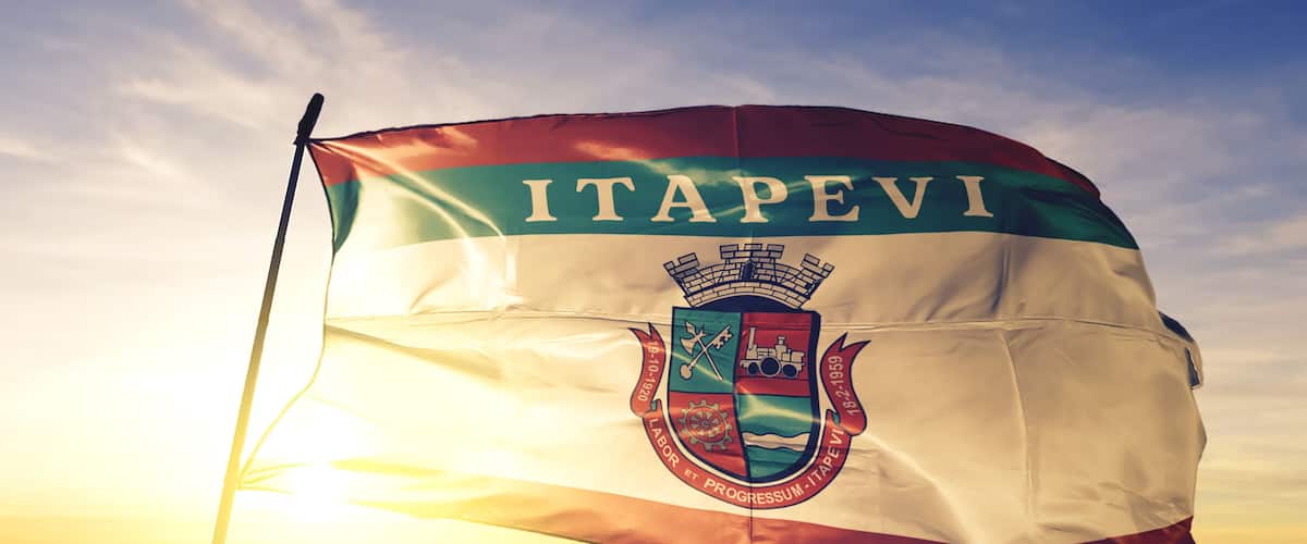 Itapevi of Brazil flag waving on the top sunrise mist fog