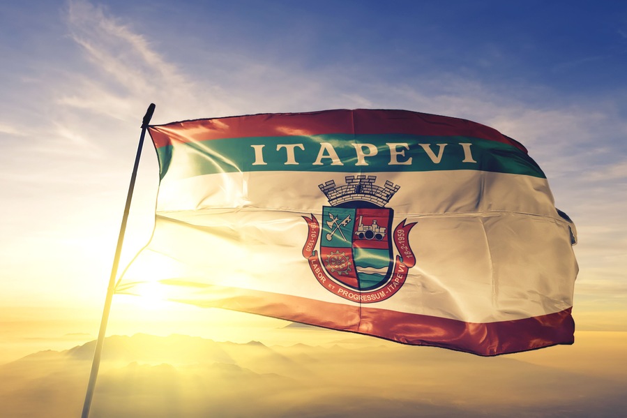Itapevi of Brazil flag waving on the top sunrise mist fog