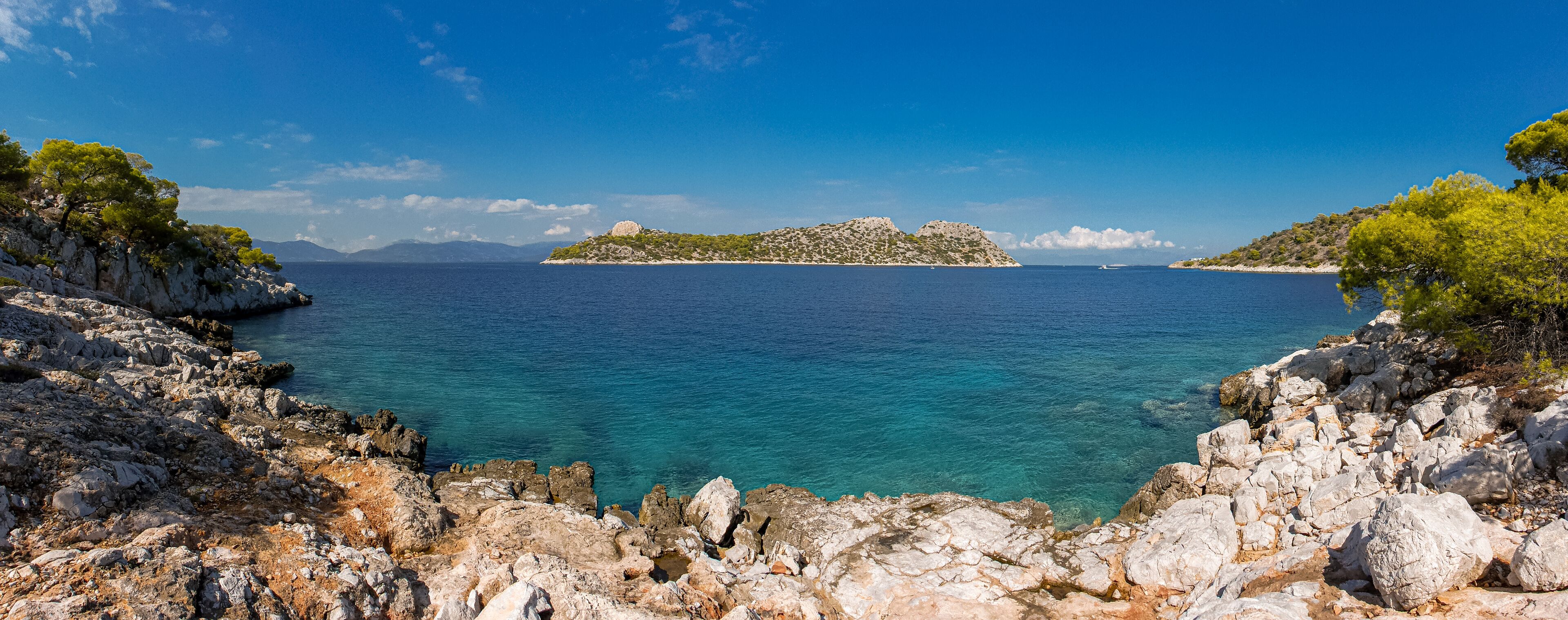 Summer sunny day beautiful view from the coast of Agistri island to the Dorousa island, Aponissos bay, Saronic Gulf, Greece.