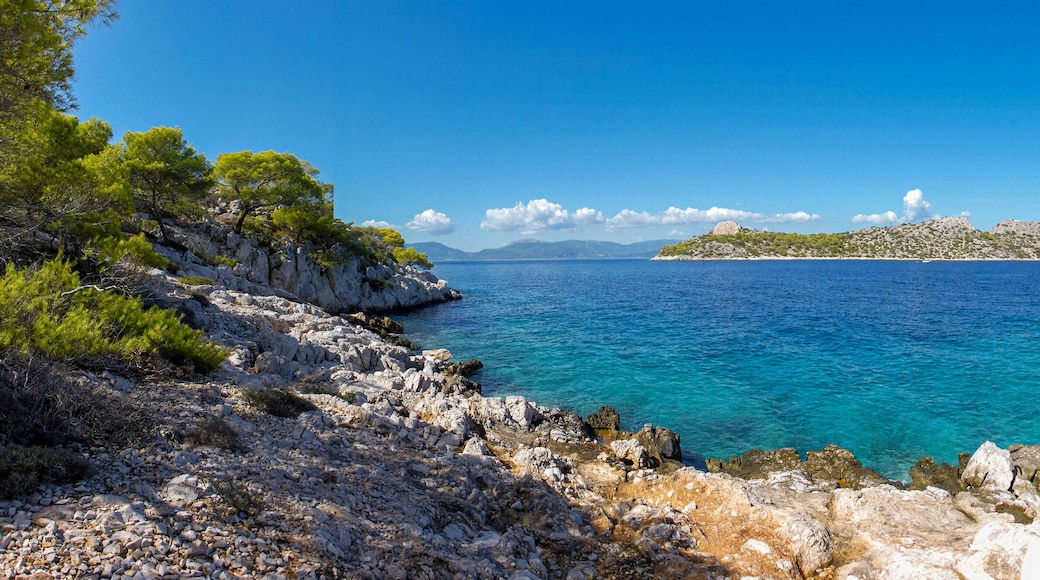 Summer sunny day beautiful view from the coast of Agistri island to the Dorousa island, Aponissos bay, Saronic Gulf, Greece.