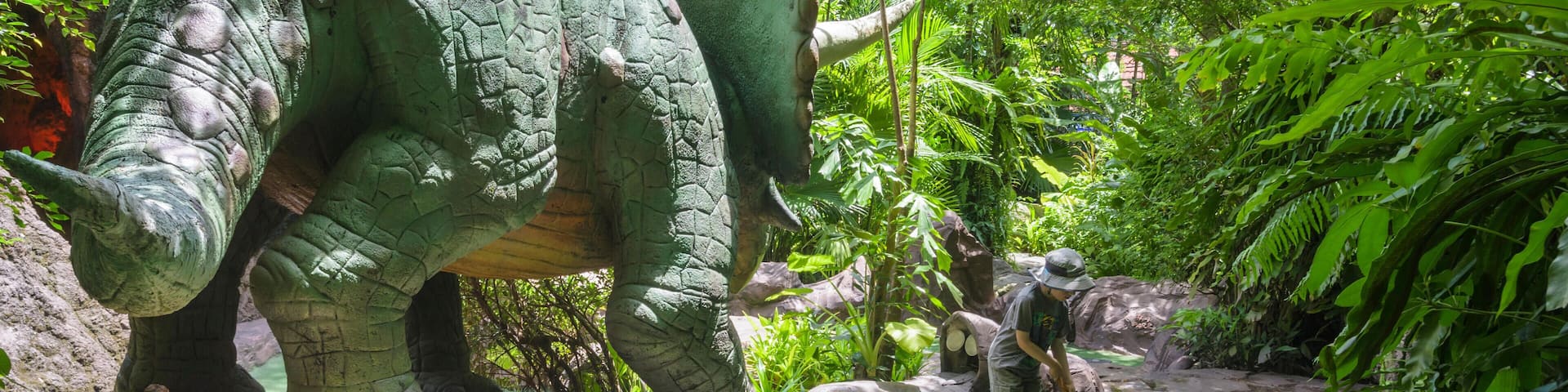 Child playing Dino Park Mini-Golf in Kamala Beach, Phuket Island, Thailand. Image shot 2014. Exact date unknown.