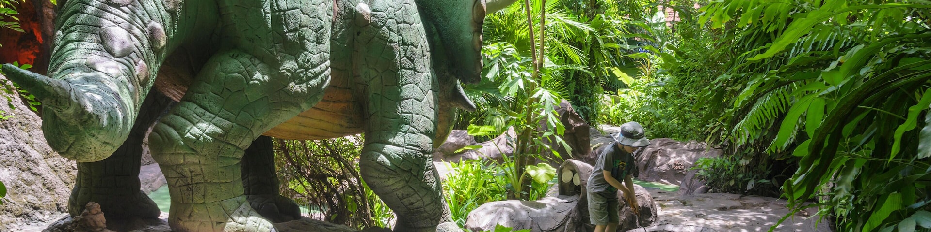 Child playing Dino Park Mini-Golf in Kamala Beach, Phuket Island, Thailand. Image shot 2014. Exact date unknown.