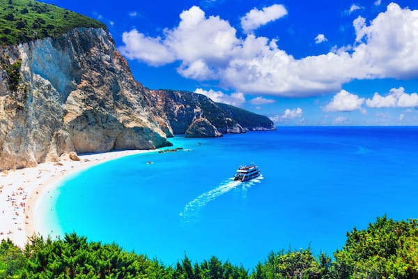 Ultra-wide high resolution panorama of Porto Katsiki beach, Lefkada. view of white cliffs, excursion boat and turquoise Ionian sea in Greece.