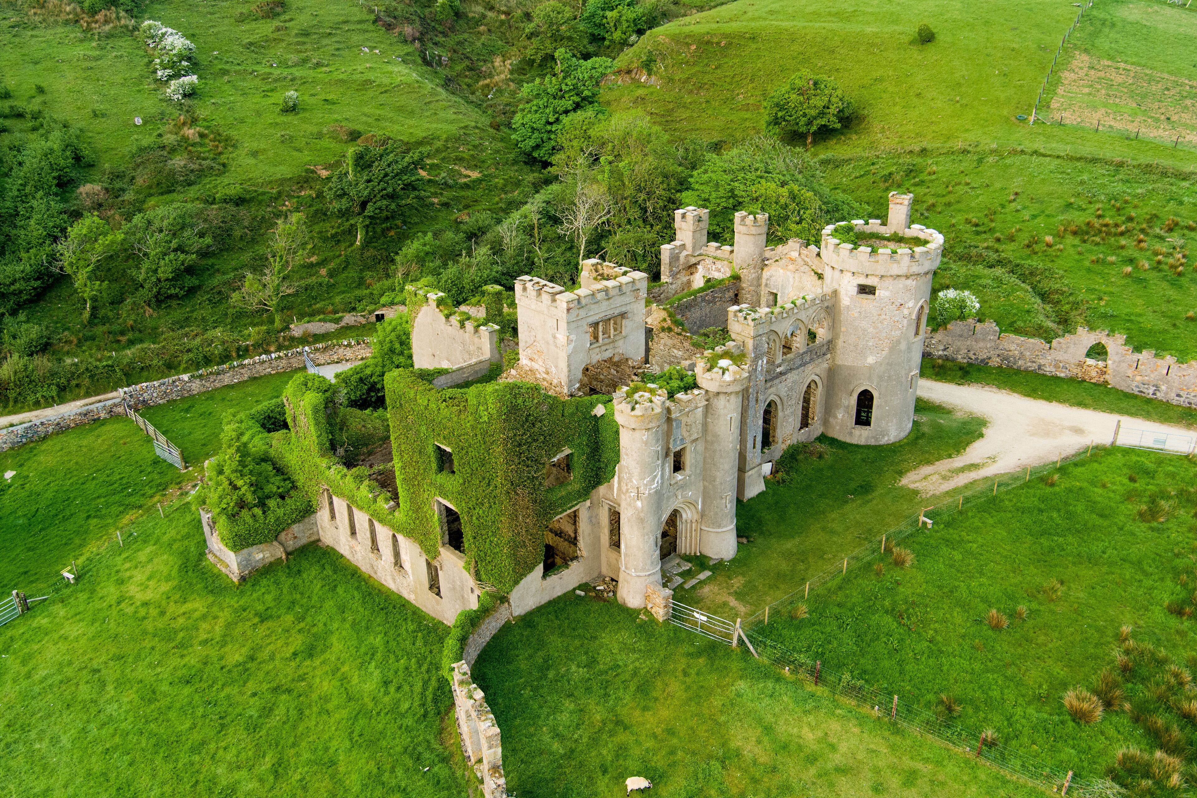 Aerial view of Clifden Castle, ruined manor house, standing on Sky Road near Clifden town, great example of Gothic Revival architecture, history, heritage of Connemara Co. Galway, Ireland